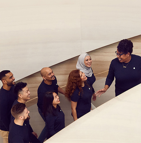 Team members ascending the stairs at an Apple Store location.