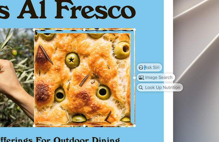 Egy olívás focaccia kijelölt képe mellett az „Ask Siri” (Kérje meg Sirit), az „Image Search” (Képkeresés) és a „Look Up Nutrition” (Tápanyagok definiálása) lehetőségek szerepelnek.
