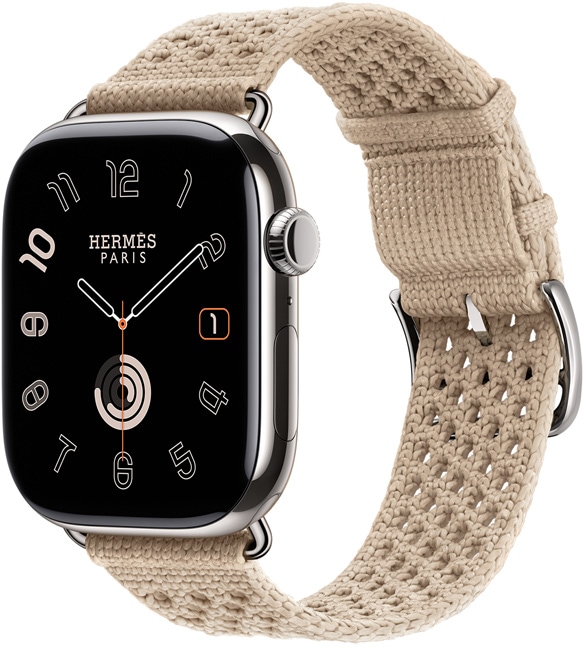 ساعة Apple&nbsp;Watch&nbsp;Hermès&nbsp;Series&nbsp;11، إطار تيتانيوم، لون فضي، طلاء خارجي مصقول، شاشة تغطي الواجهة بالكامل، زوايا مدورة، الجانب الخارجي الأيمن، التاج الرقمي، ميكروفون، زر جانبي، واجهة الساعة Circulaire (عقارب الساعة والدقيقة والثانية، شعار Hermès&nbsp;Paris)، مع حزام Néo&nbsp;Tricot، لون argile (بيج)، نسيج محبوك من خيوط البولي أميد، فتحات تعديل في الوسط، مشبك وأجزاء بلون فضي