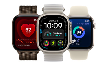 Three Apple Watch devices: Apple Watch Series 12, rose gold color, aluminum case, Apple Music, playlist controls, right side exterior, Digital Crown, light blush color Sport Band, silver pin-and-tuck closure, Apple Watch Ultra 4, natural color, titanium case, edge-to-edge display, photo overlaid on time, right side exterior, Digital Crown, anchor blue color Ocean Band, tubular fluoroelastomer rubber, Apple Watch SE 3, aluminum case, midnight color, right side exterior, Digital Crown, advanced Outdoor Run workout metrics