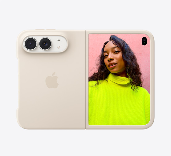 iPhone Duo, Star White color in Sand Silicone Case, landscape orientation, fully opened horizontally, Dual Fusion cameras on the top left, case covers the back exterior and outer edge of the front display, right side features the outer display with an image of a person standing under a cloud-filled blue sky