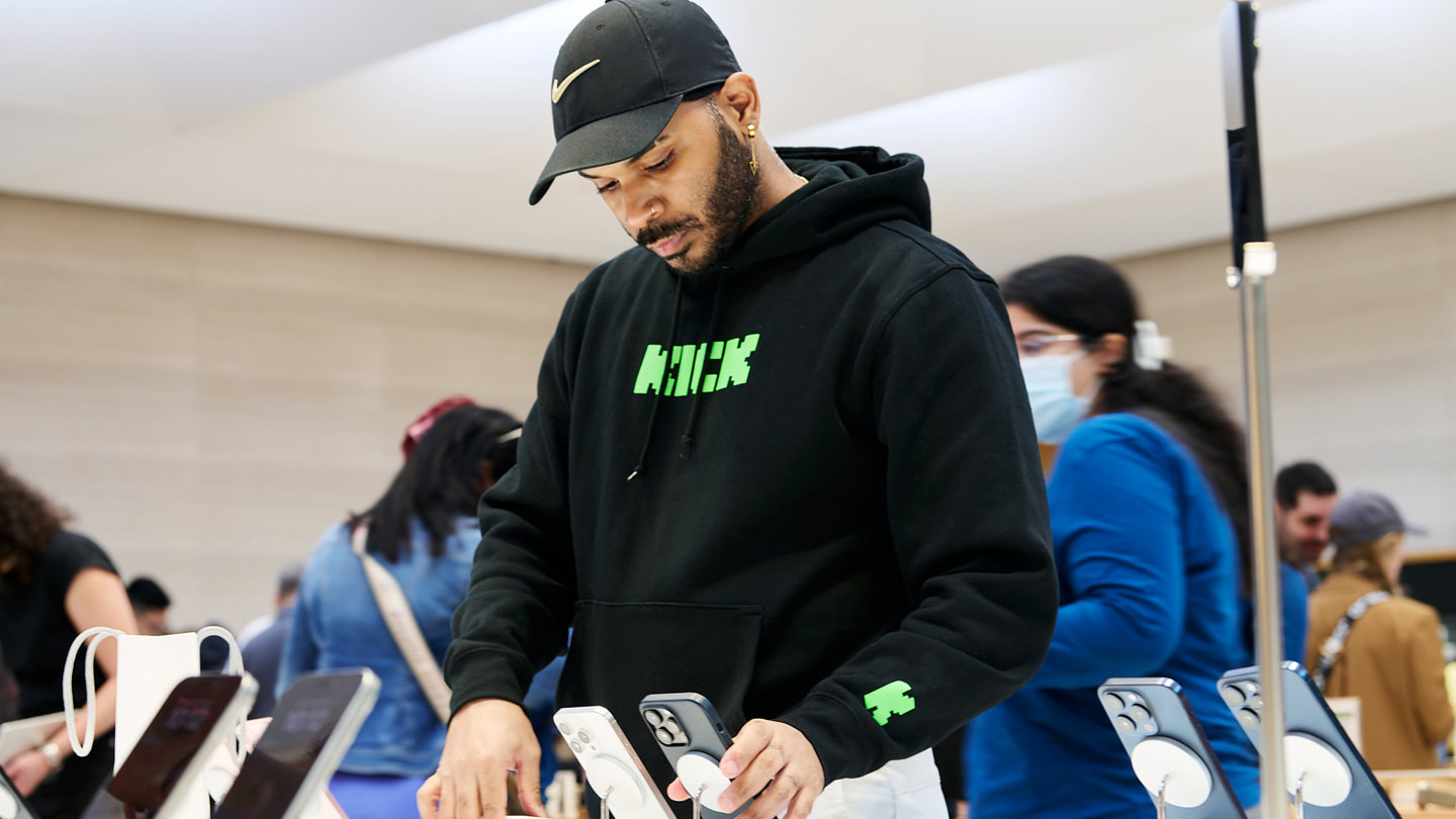 A customer explores the iPhone 15 lineup at Apple Fifth Avenue in New York City.