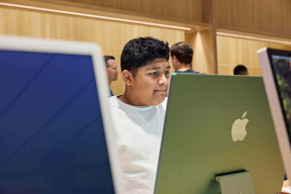 A customer explores the latest Mac lineup at Apple Miami Worldcenter.