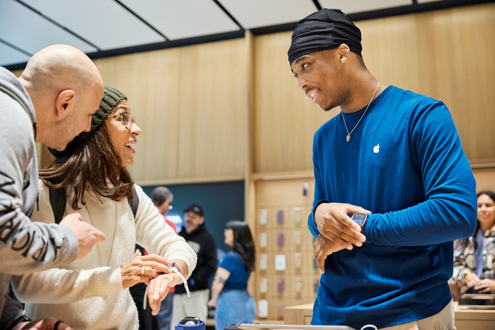 Customers explore the Apple Watch lineup with assistance from an Apple team member at Apple Miami Worldcenter.