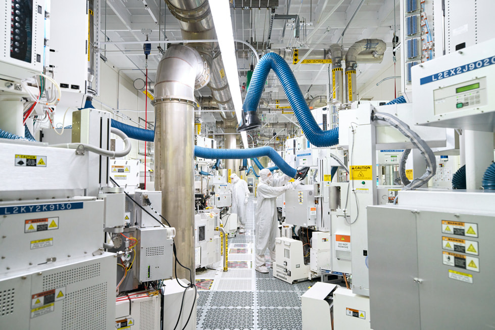 Workers with machinery at Texas Instruments’ semiconductor wafer fabrication plant in Lehi, Utah.
