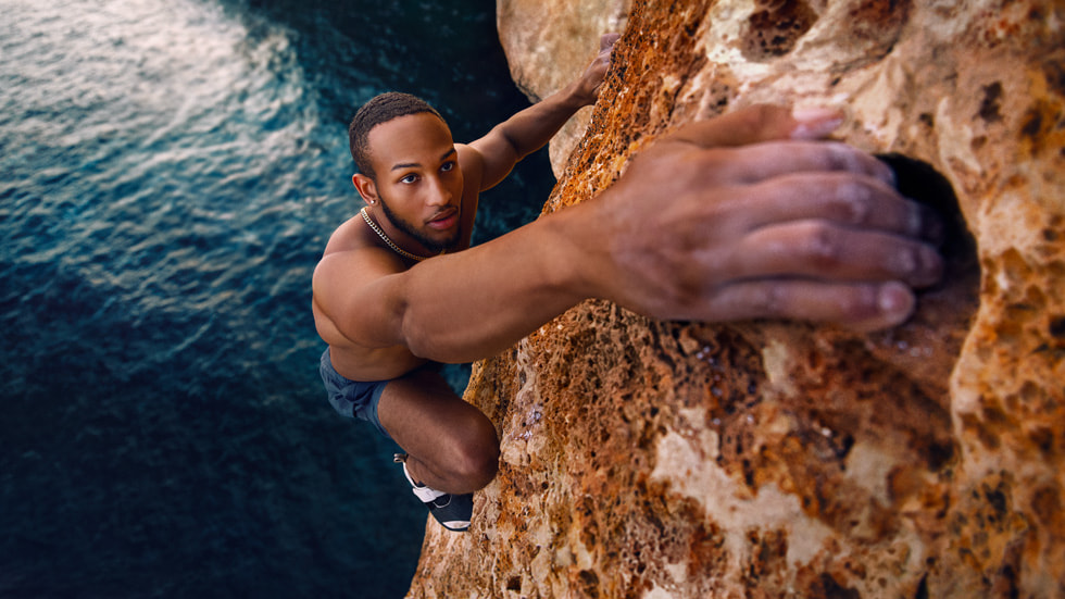 Kai Lightner climbing above water in Spain.