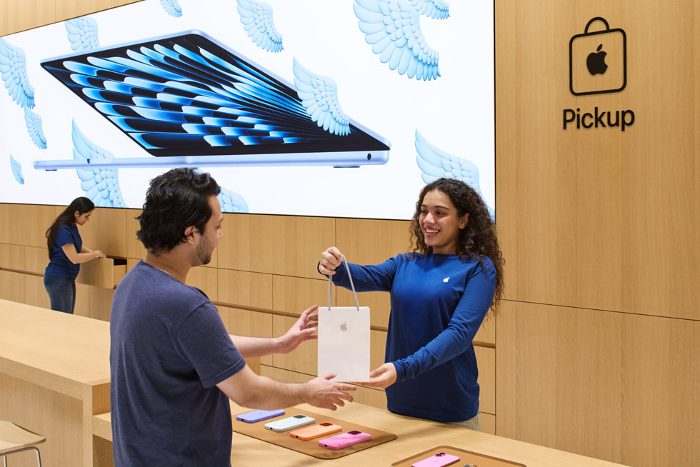 Team members assist customers at the Apple Pickup area inside Apple Koregaon Park.