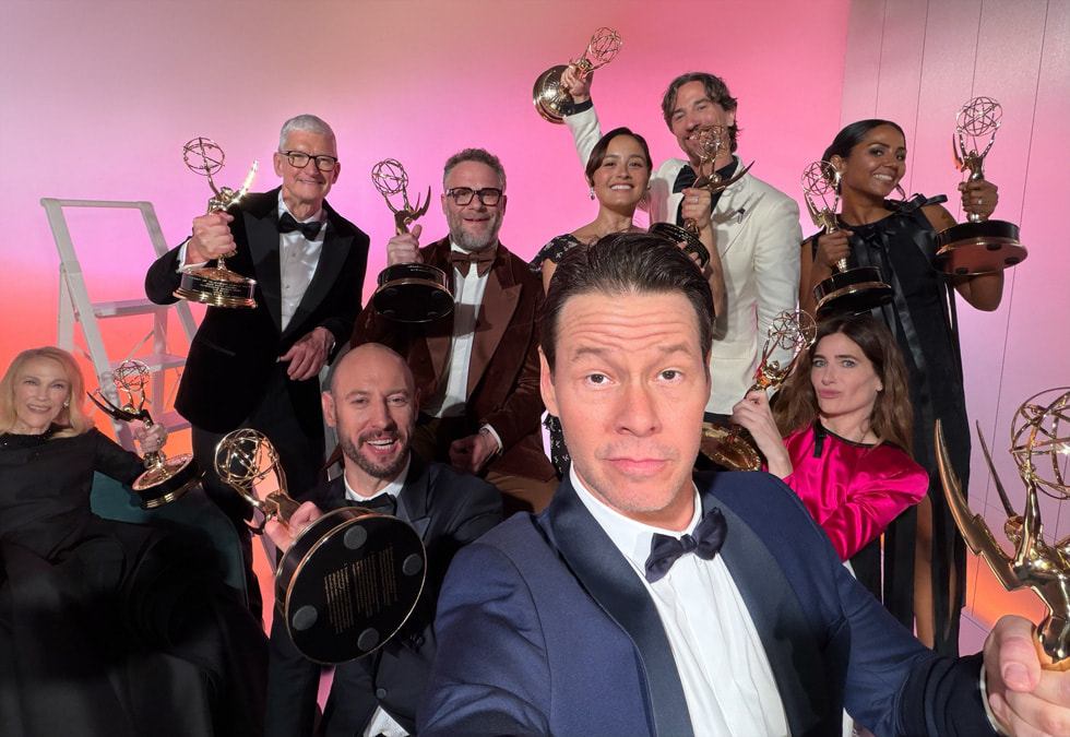 Cast and crew from the Apple TV+ series “The Studio” pose for a group selfie with Emmy Award statuettes in hand.