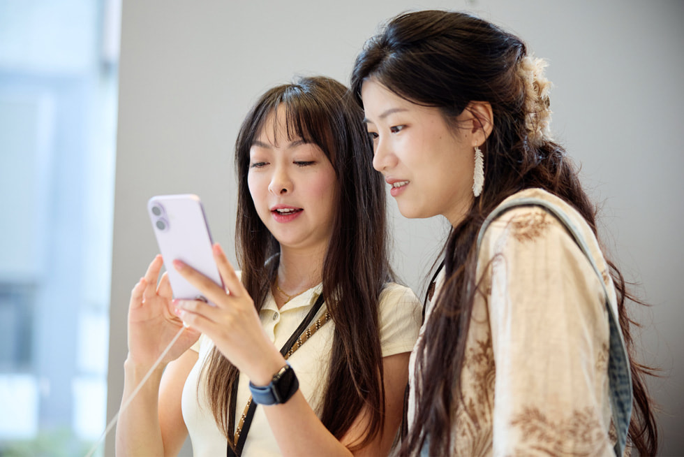 Two customers test out the new iPhone 17 at Apple Nanjing East in Shanghai.