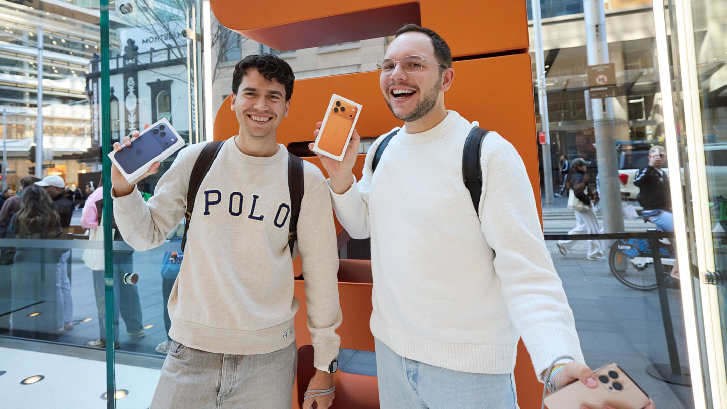 Two smiling customers proudly pose with their iPhone 17 Pro purchases at Apple Sydney in Sydney, Australia.