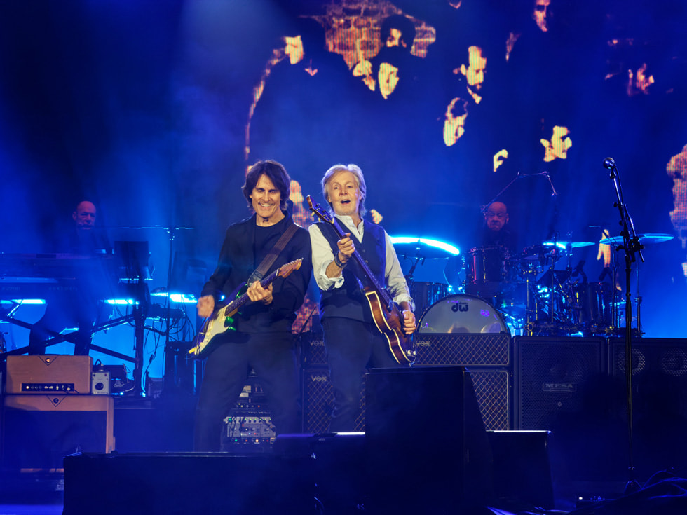 Paul McCartney plays guitar with a fellow guitarist on stage at Apple Park in Cupertino.