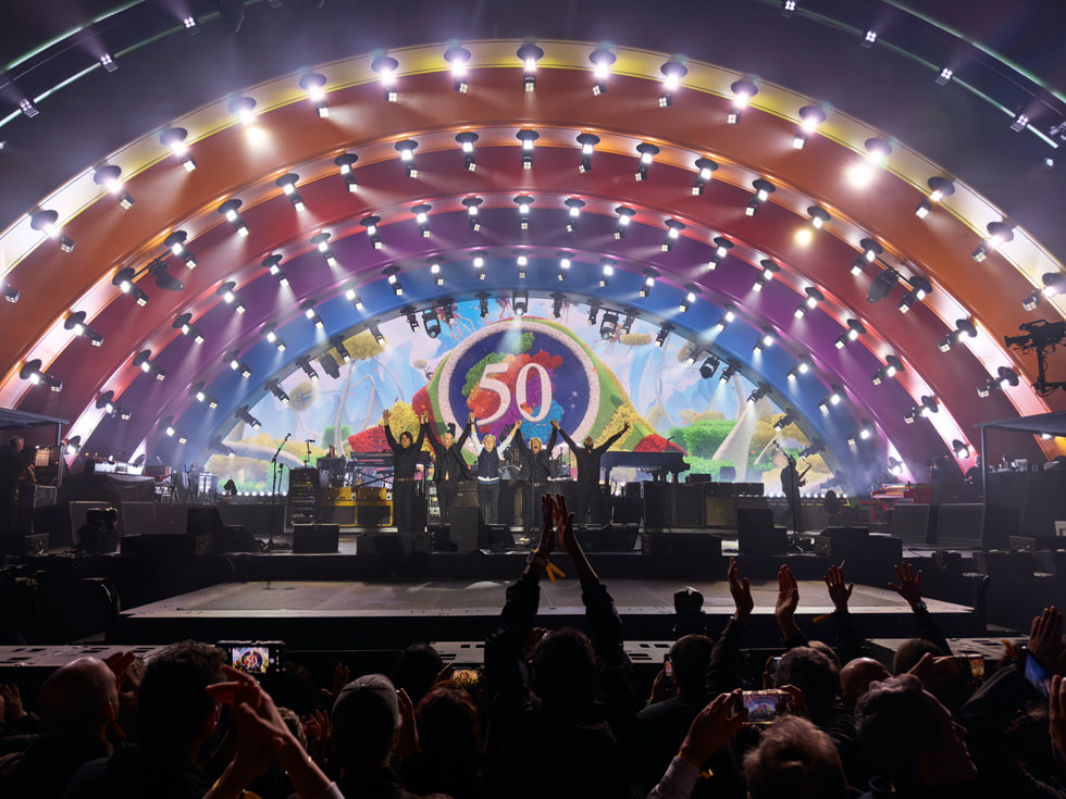 The full band is shown taking at bow on the stage at Apple Park in Cupertino.