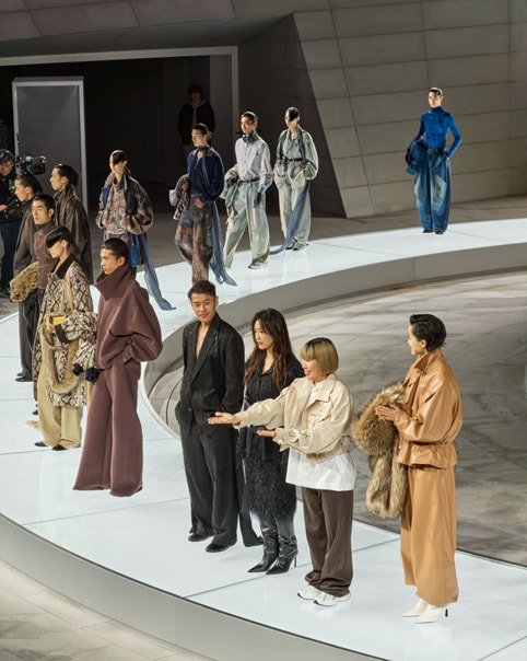 Models stand on a circular runway at Apple Jing’an alongside designer Feng Chen Wang.