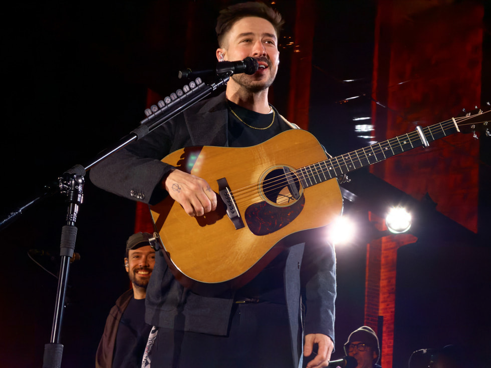 Marcus Mumford pictured singing and playing guitar at Apple Battersea in London.