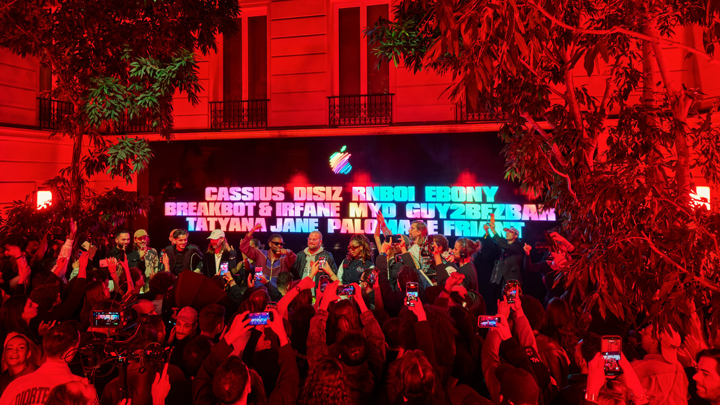 Performers stand on the stage at Apple Champs-Élysées in Paris.