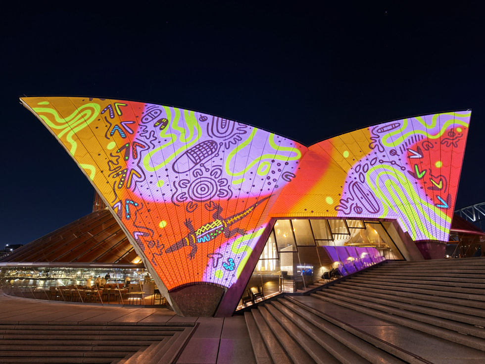 An artist’s Bennelong sails projection by Kentaro Yoshida shows surfers amid towering waves.
