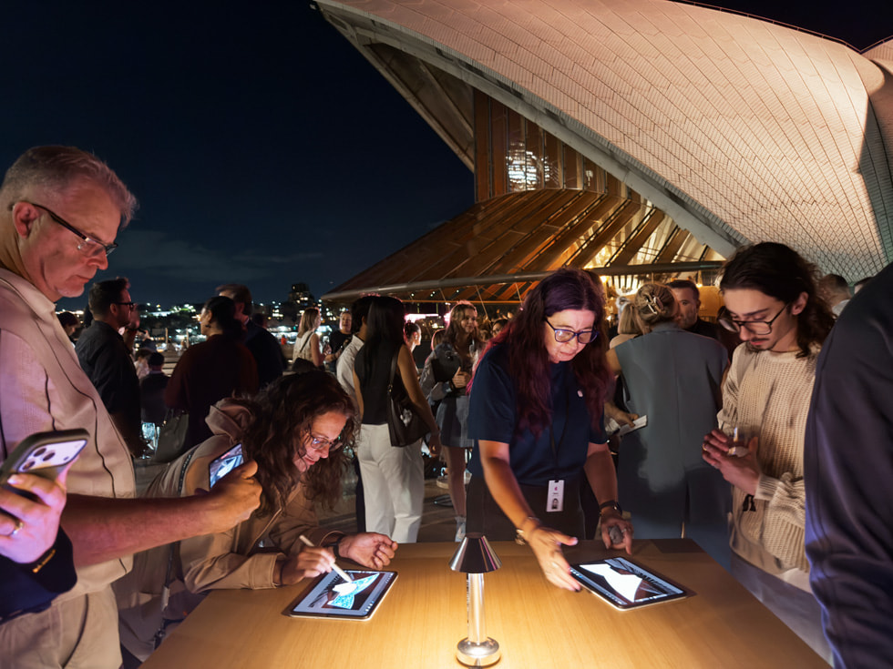 A close-up of people creating artwork on iPad with Apple Pencil.