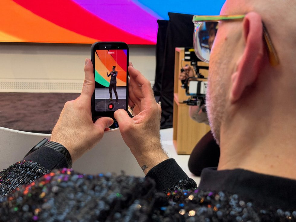 An attendee at the event at Apple Carnegie Library in Washington, D.C. films a video on iPhone.