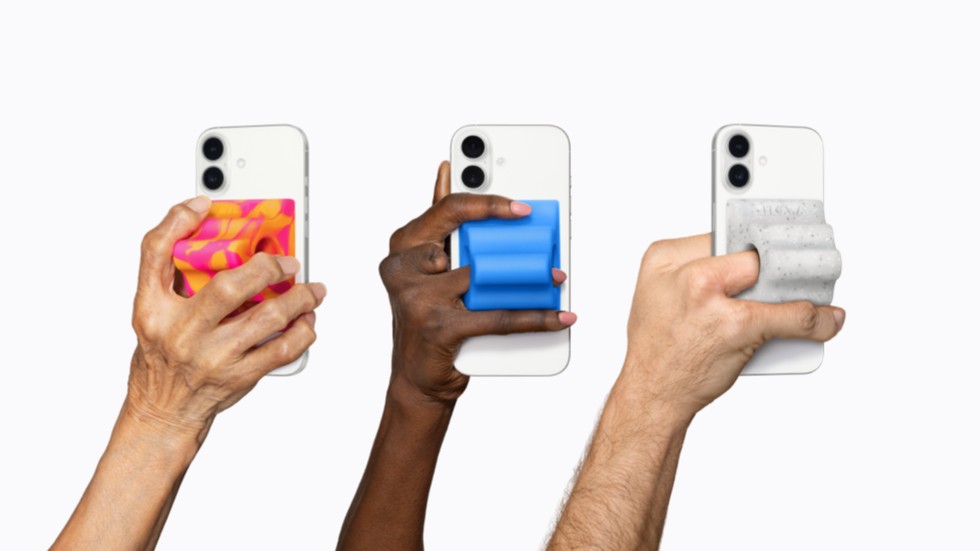 Three hands hold iPhone 17 Pro devices, each equipped with a colorful Hikawa Grip & Stand adaptive accessory.