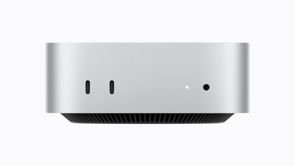 The front of Mac mini is shown, including its two USB-C ports that support USB 3 and a headphone jack.