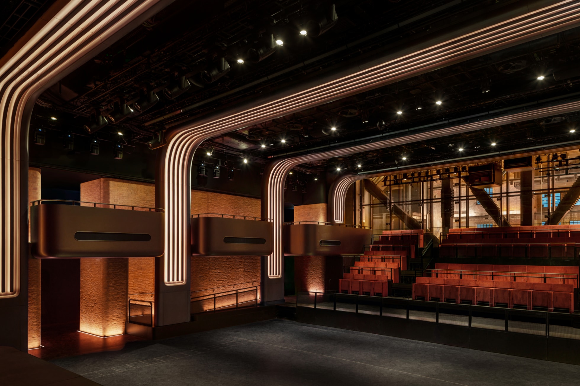 The performance space inside Apple Music Studios, complete with comfortable seating and a variety of lighting options.
