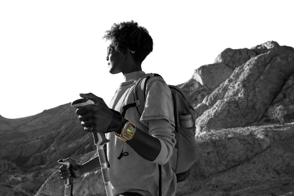 A black-and-white photo of a hiker wearing Apple Watch Ultra 4.
