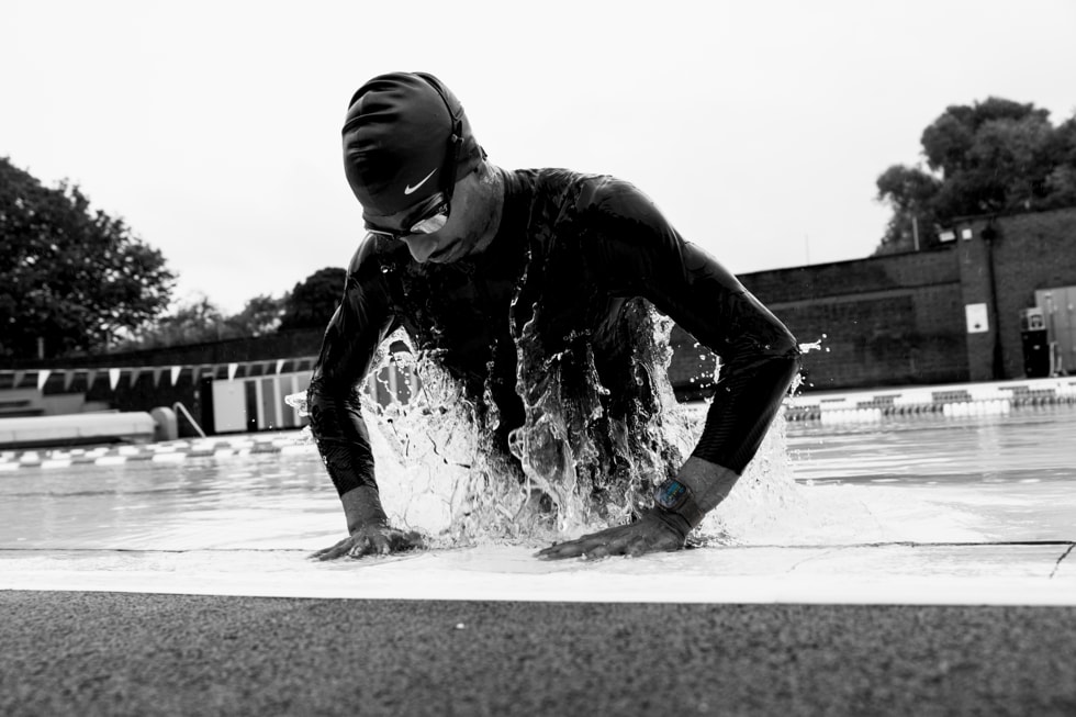A black-and-white photo of a swimmer wearing Apple Watch Ultra 4.