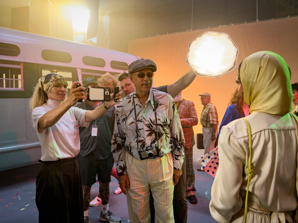 Photographer Alex Prager is shown holding iPhone 18 Pro on set.