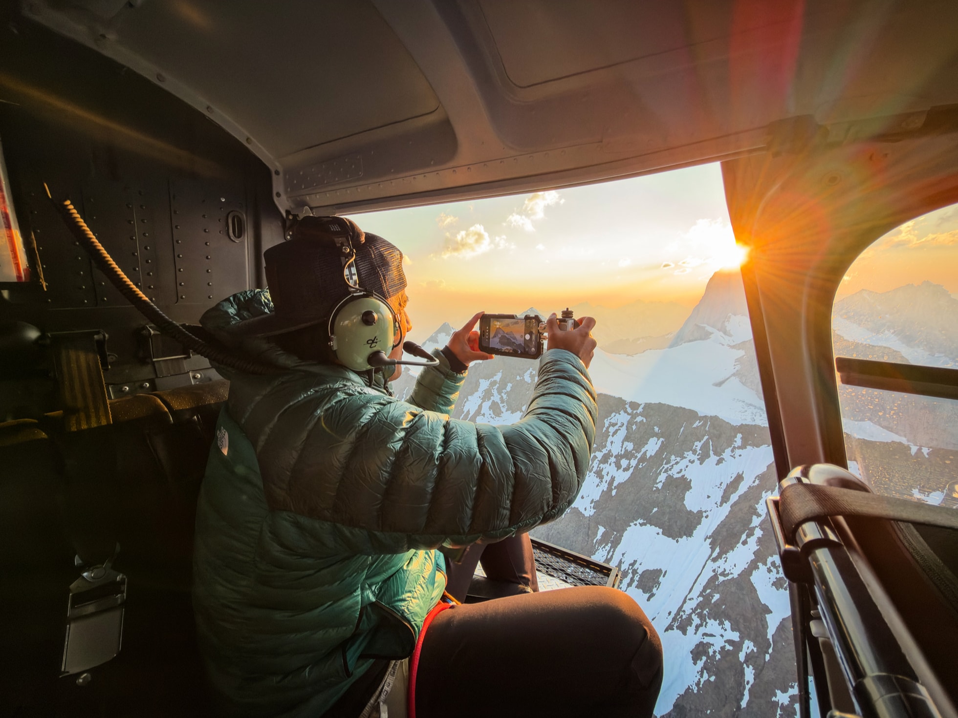 Photographer Jimmy Chin is shown holding iPhone 18 Pro in a helicopter.
