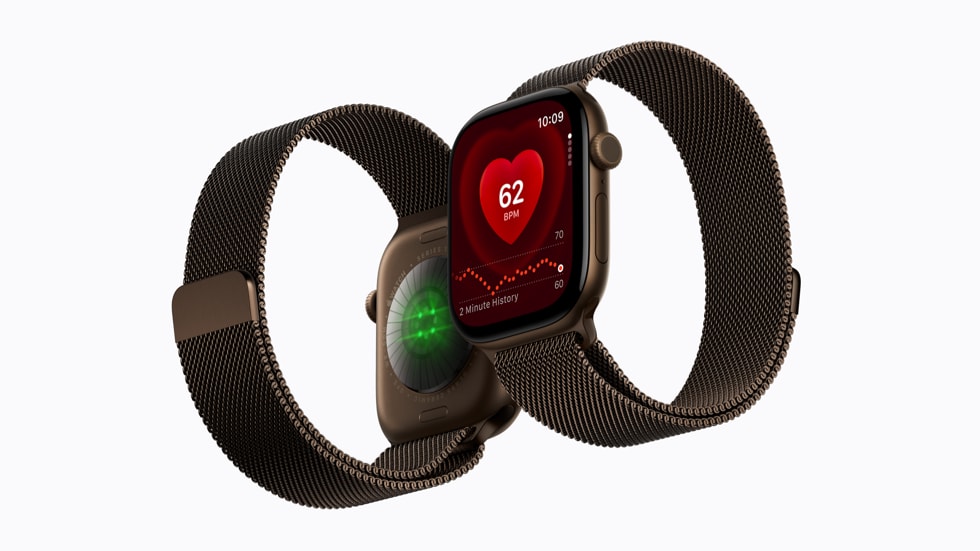 Two Apple Watch Series 12 devices are pictured side by side, with the sensors shown on the back of one and the Heart Rate app shown on the face of the other.