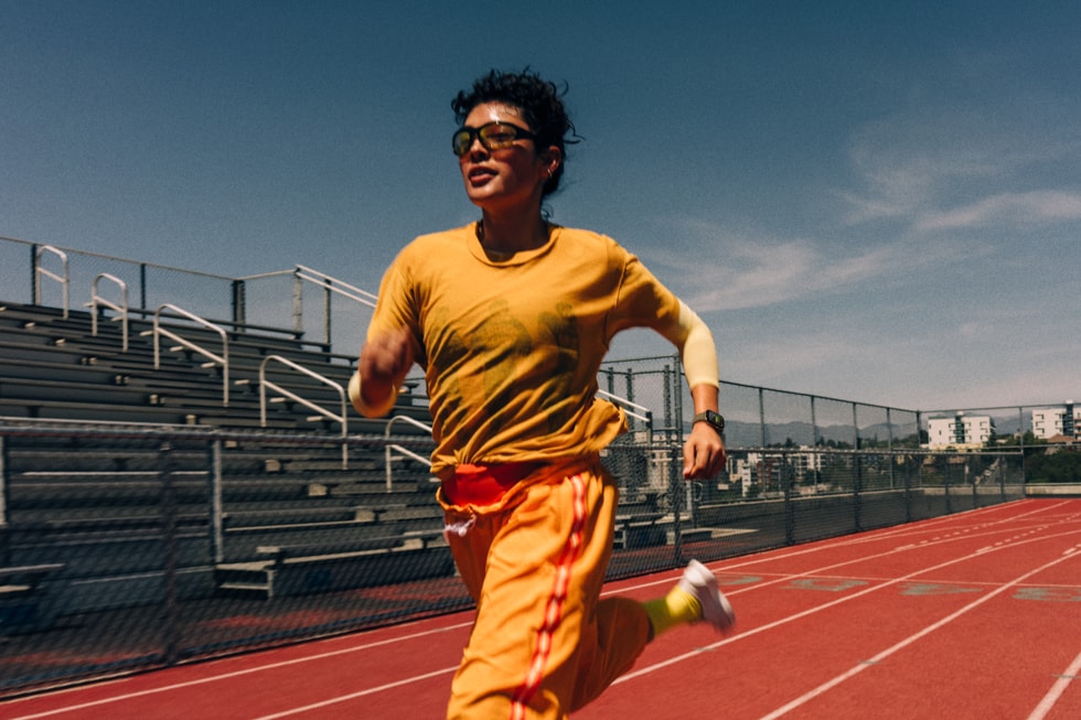 An Apple Watch Series 12 user is pictured running on a track.