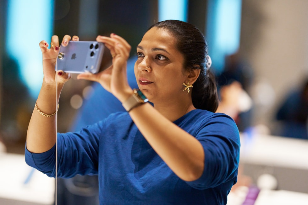 A customer holds up iPhone 18 Pro at Apple BKC.