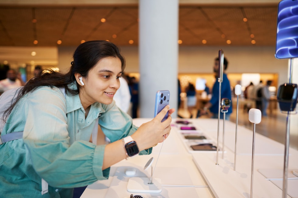 A customer tries out AirPods 5 and iPhone 18 Pro at Apple BKC.