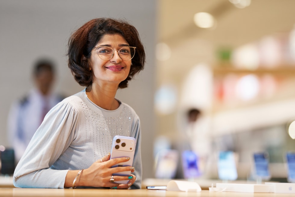 A customer poses with iPhone 18 Pro at Apple BKC.