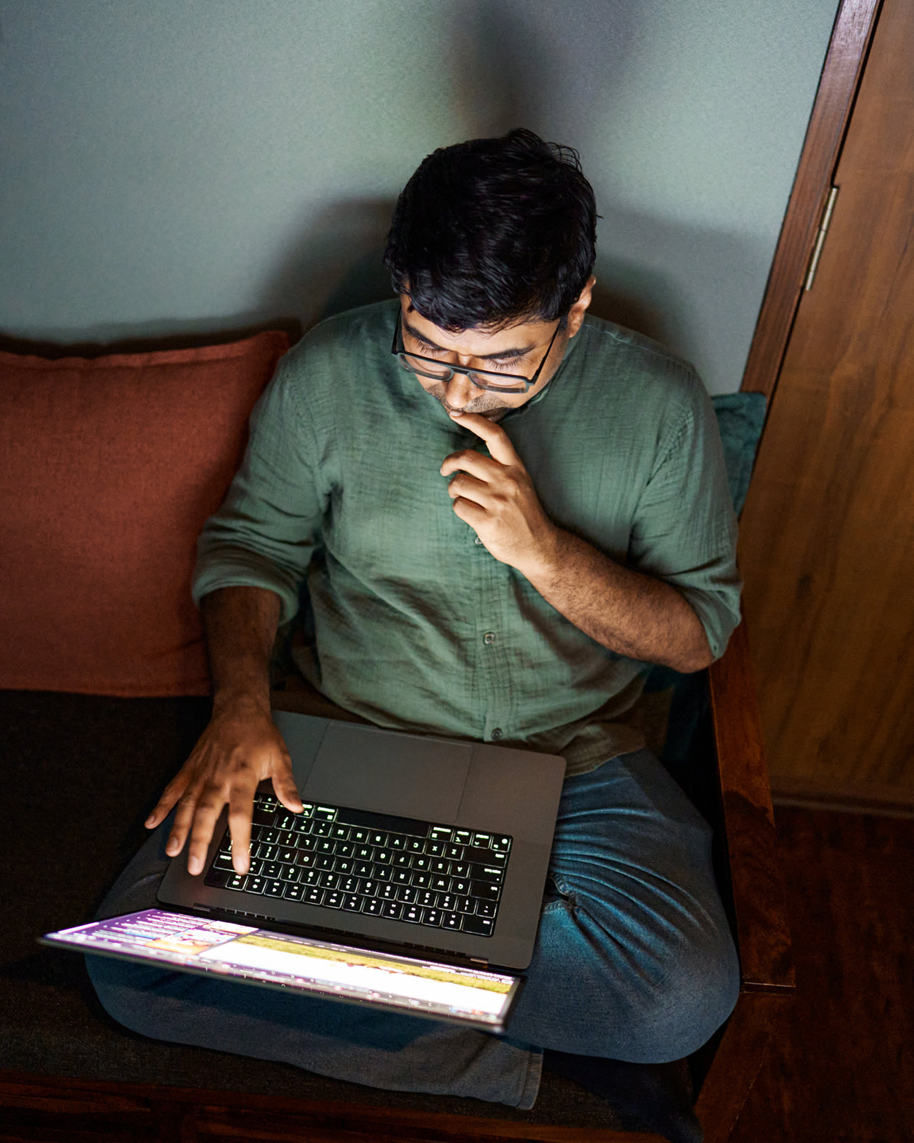 A portrait of filmmaker Chanakya Vyas working on MacBook Pro.