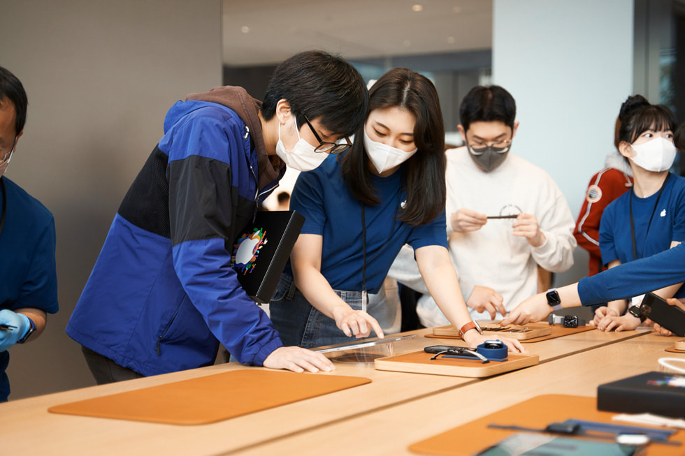 Customers and team members are shown at Apple Myeongdong.