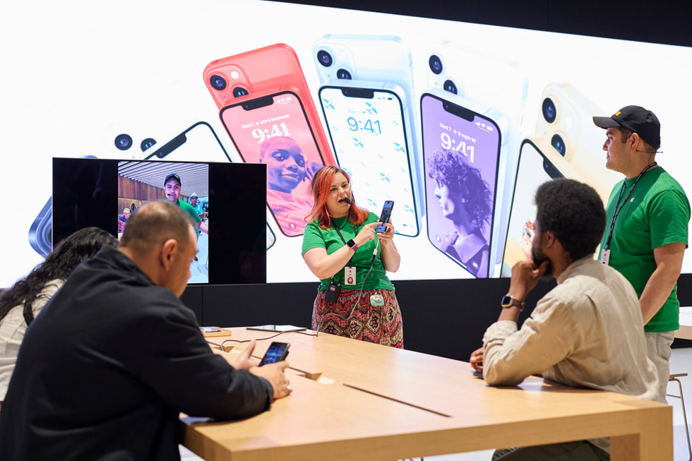 Customers are shown gathering around the Today at Apple table at Apple Tysons Corner.