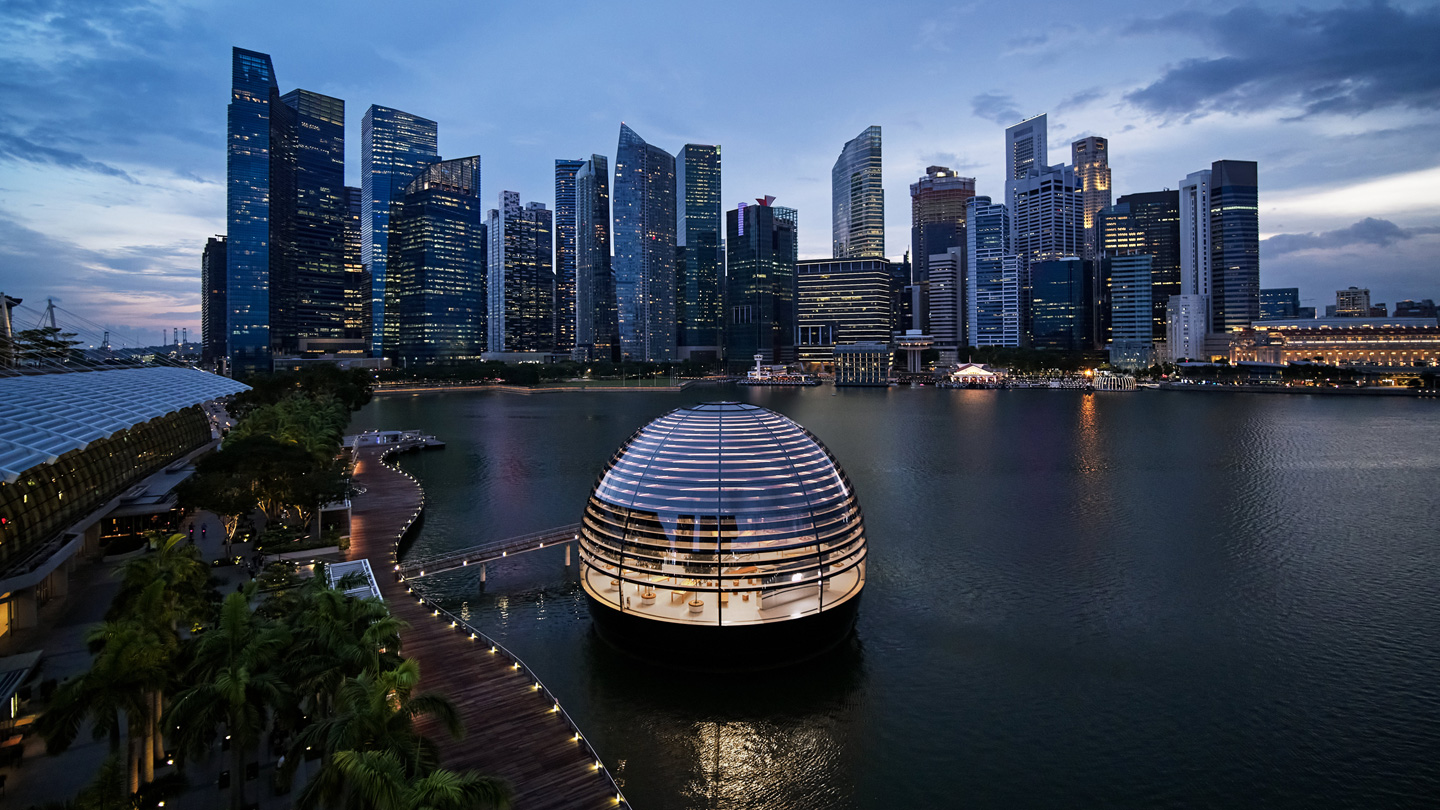 Exterior of Apple Marina Bays Sands dome with the city skyline.