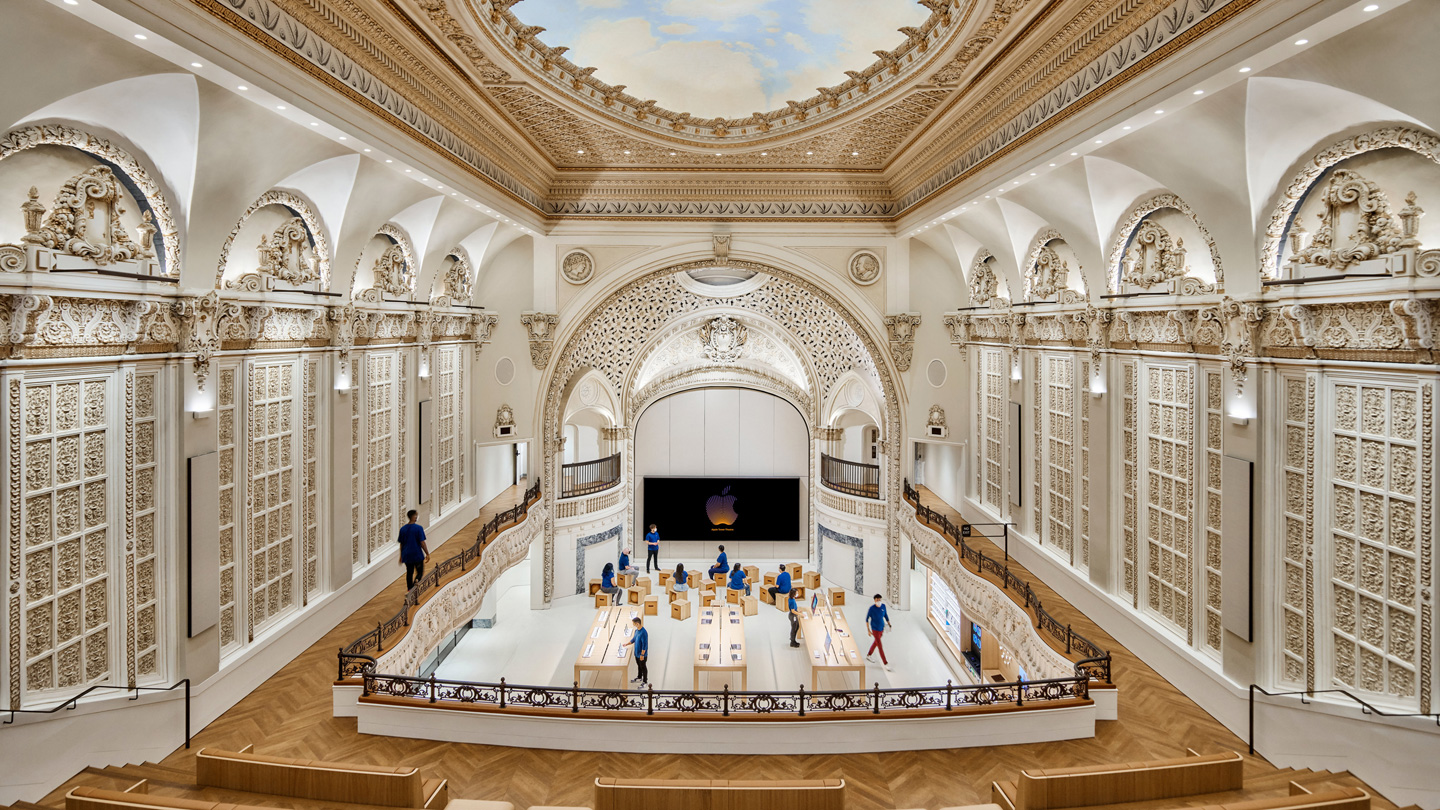 A view inside Apple Tower Theatre shows the dome, balcony, Forum, and main sales floor.