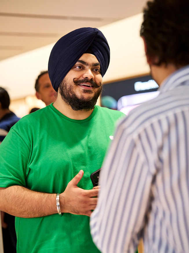 An Apple team member speaks with a customer.