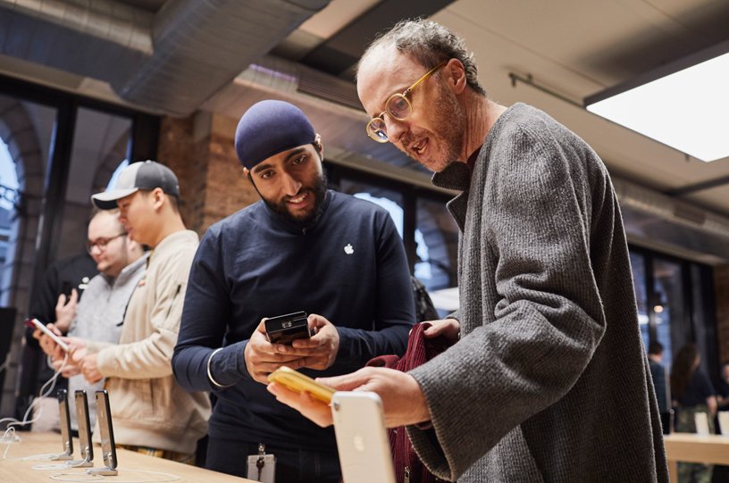 An Apple Covent Garden team member discussing the iPhone XR with a customer.