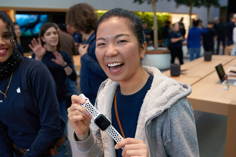 A woman holds up a new Apple Watch Series 4.
