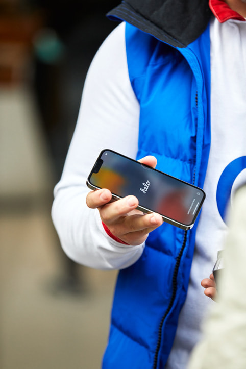 An Apple Regent Street customer setting up his new iPhone 13.