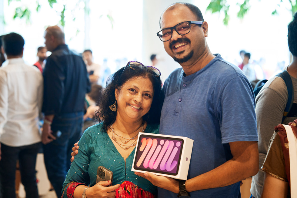 A customer poses with his new iPad mini.