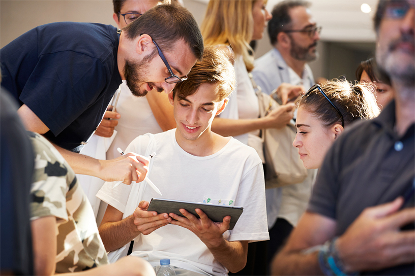 A Creative Pro collaborates with a visitor.