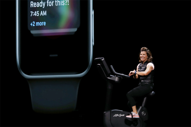 Julz Arney demos watchOS on a stationary bike on stage at WWDC 2018.