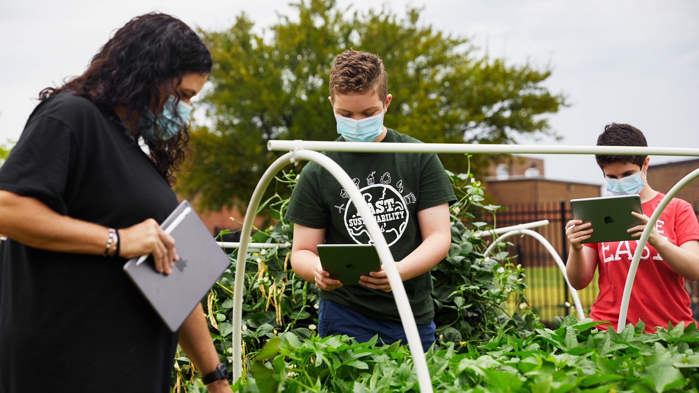 Jodie Deinhammer, Stayton Slaughter, and Annabeth Hook working in Coppell Middle School East’s community garden.