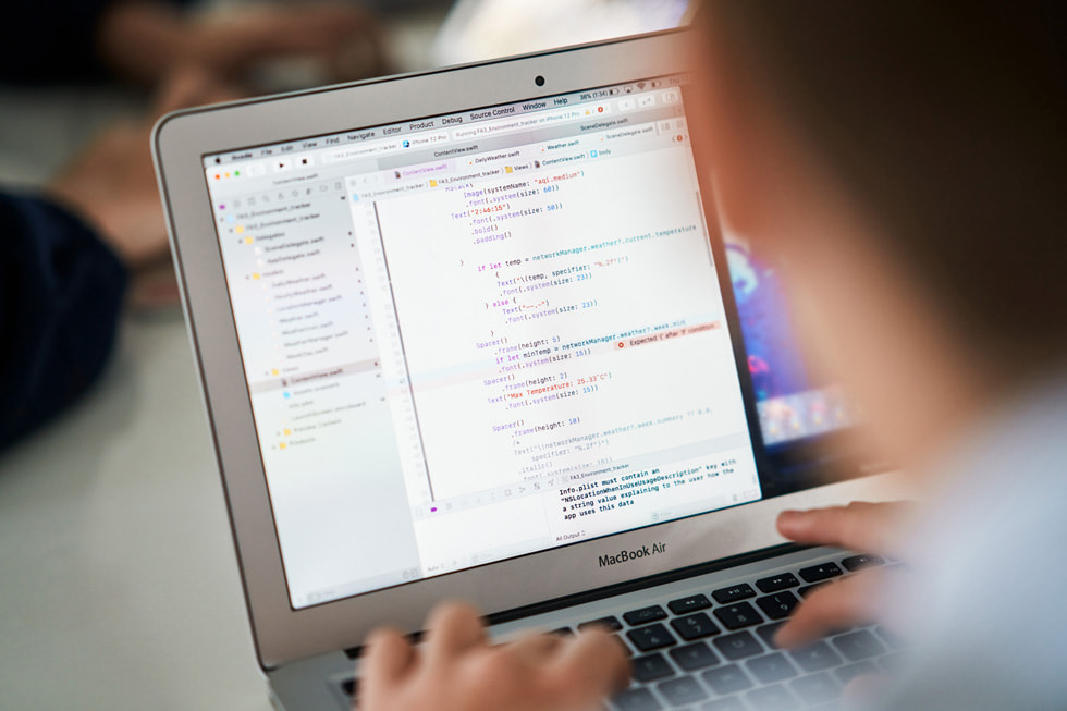 A student reviews code on MacBook Air.