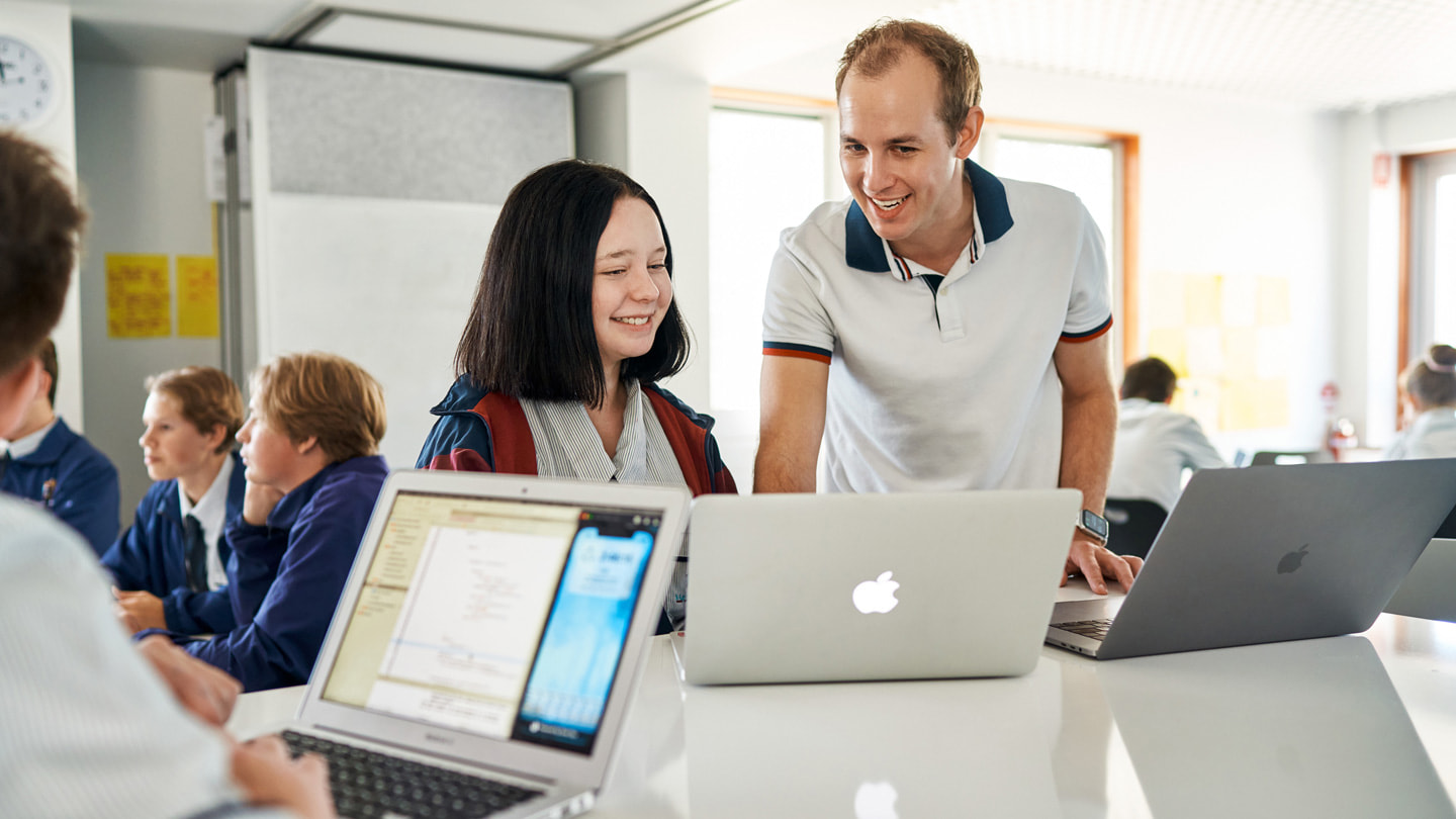 Oliver Baumeister teaches Swift using MacBook Pro and MacBook Air to students at St Augustine’s College.