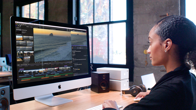 Woman using Final Cut Pro X on iMac.